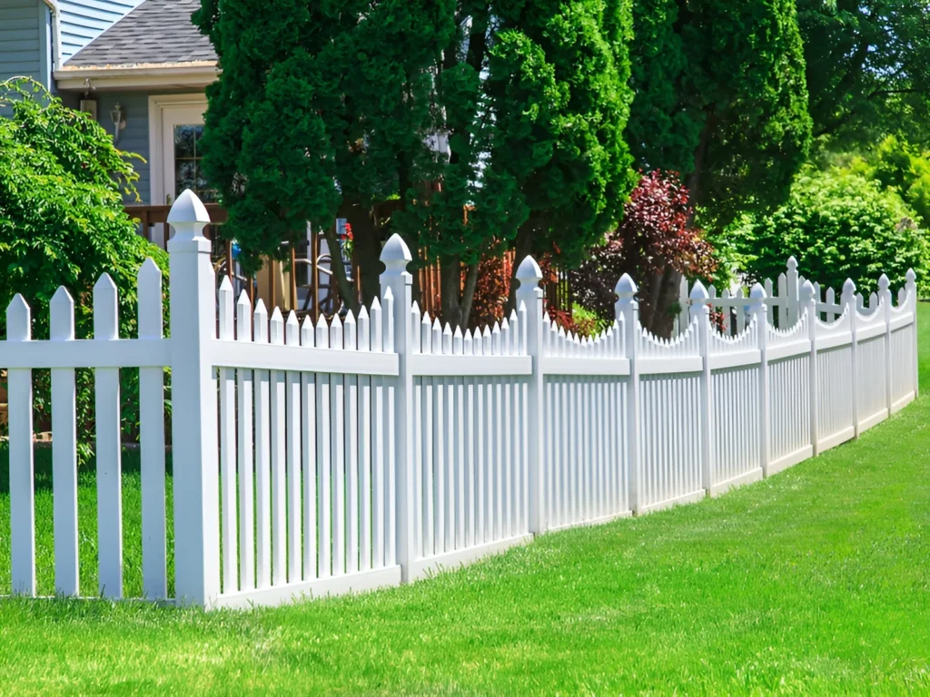 An image showing a durable vinyl fence with decorative vinyl posts in a sunny backyard.
