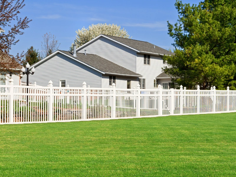 Image of vinyl and cedar fencing under the desert sun.