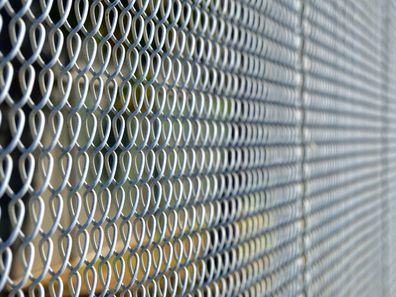 A chain link fence hardware and tension band installation.
