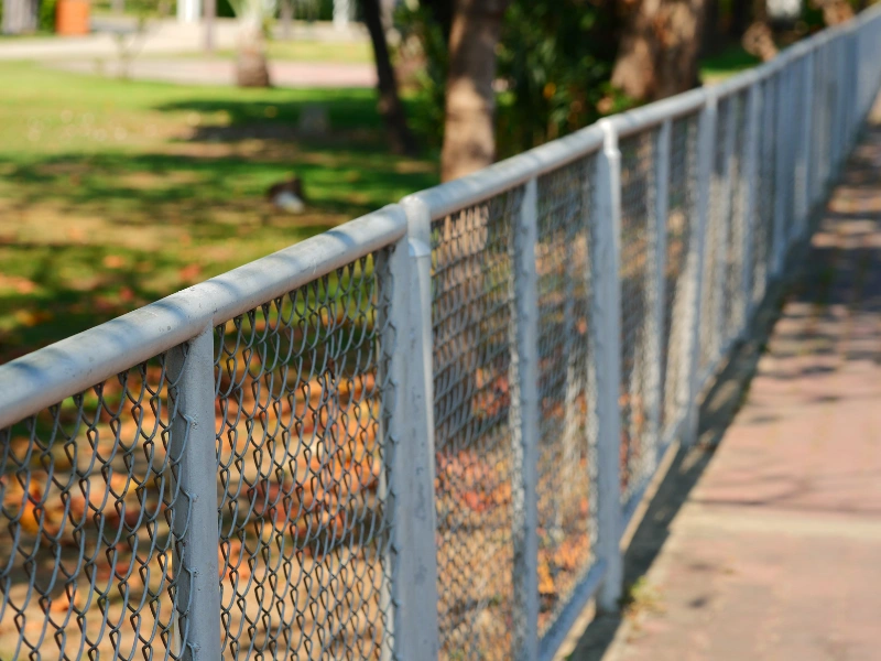 Chain link fence posts and a top rail framework installed in Phoenix.