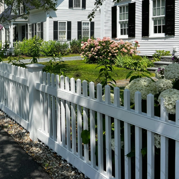 Decorative white vinyl picket fence at a Arizona residential property.