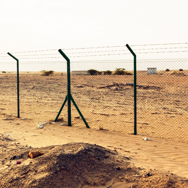 Fence installation site preparation in Phoenix desert soil.